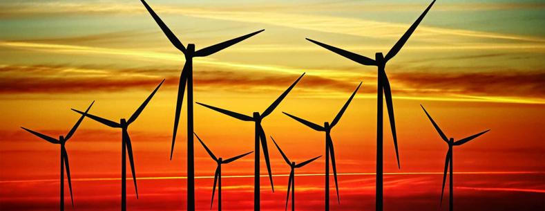 Still wind turbines at sunset