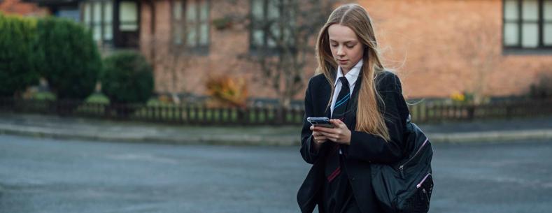 This is a photo of a school pupil using a smartphone
