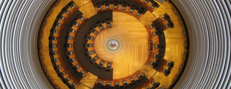 The article’s main image is a view of the Senedd Siambr from above