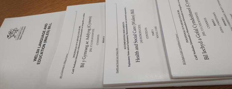 Printed versions of Senedd Bills stacked on a table top