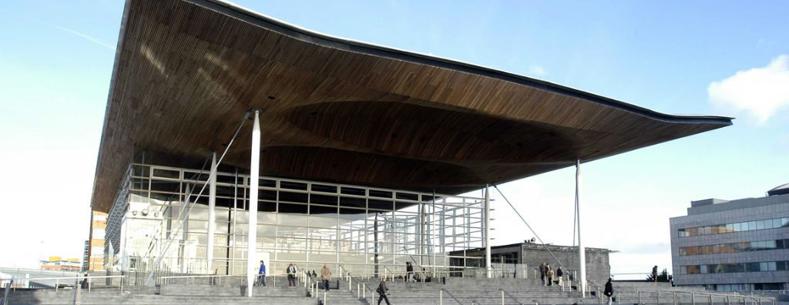 A photo of the front of the Senedd building.