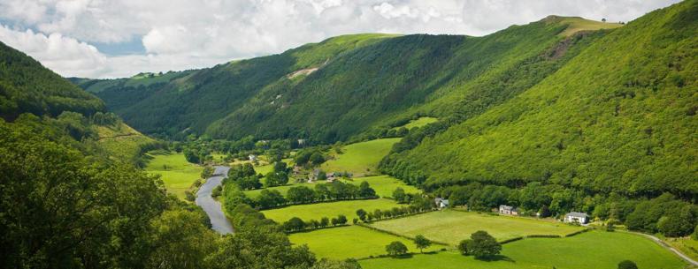 Welsh landscape. Green mountains with river running through. 
