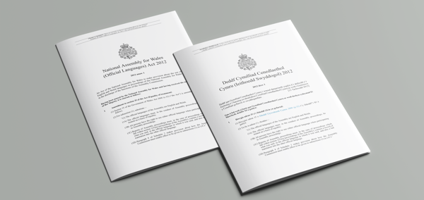 The article’s main image is of English and Welsh versions of the National Assembly for Wales (Official Languages) Act 2012.