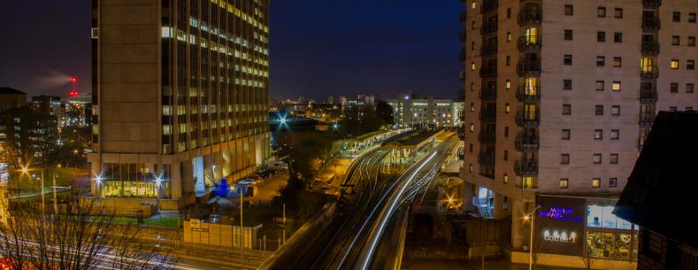This is an image of railway tracks at night entering Cardiff Queen Street Station.