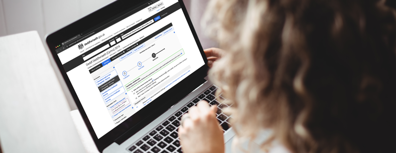 A person browsing the Legislation.gov website on a laptop. 