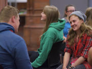 A picture of young people sitting together chatting