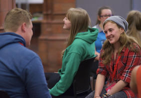 A picture of young people sitting together chatting