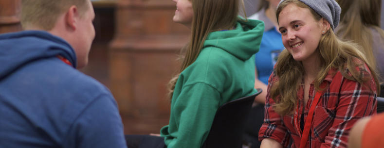 A picture of young people sitting together chatting