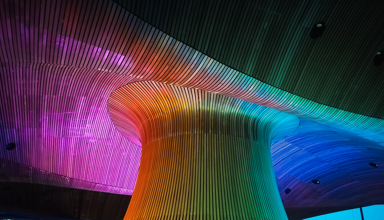 Senedd Funnel lit up in the colours of a rainbow