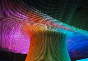 Senedd Funnel lit up in the colours of a rainbow