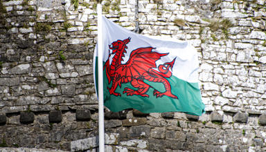 The cover image is of a Welsh flag flying in front of a castle wall.