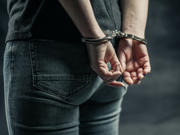Hand behind a person’s back in Handcuffs