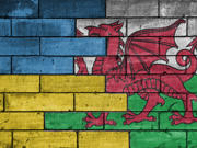 wooden blocks painted in the Welsh and Ukrainian flags meeting in the middle 