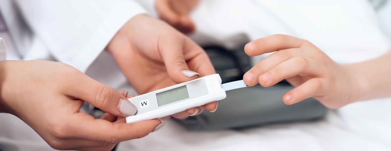 A healthcare provider giving a patient a diabetes blood test.