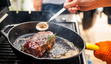 Steak being cooked in a pan