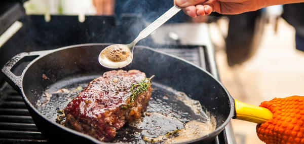 Steak being cooked in a pan