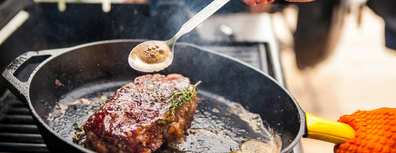 Steak being cooked in a pan