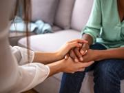 A person holding a hand of another person