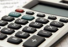 Calculator and pen on piece of paper