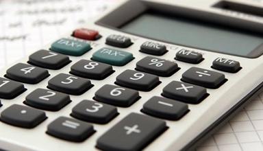 Calculator and pen on piece of paper