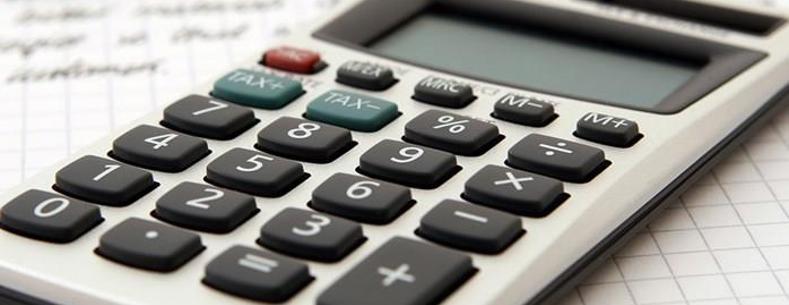 Calculator and pen on piece of paper