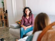 A support worker talking to someone at home