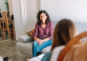 A support worker talking to someone at home