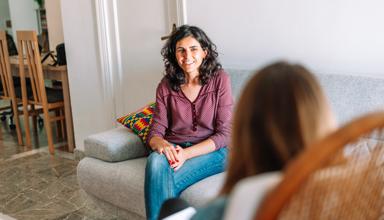 A support worker talking to someone at home