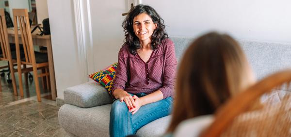 A support worker talking to someone at home