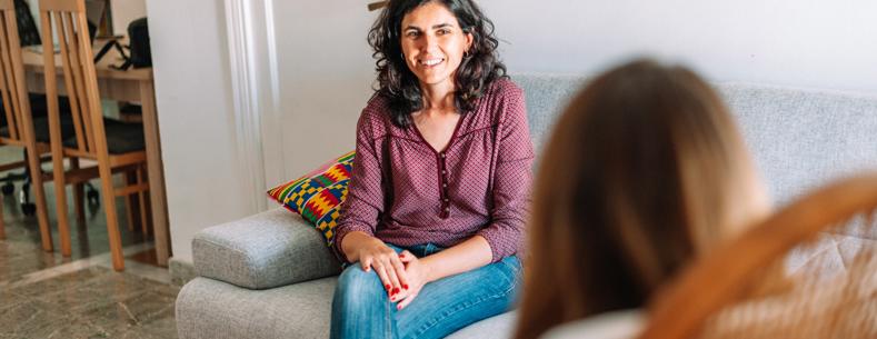 A support worker talking to someone at home