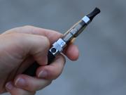 A hand holding an e-cigarette