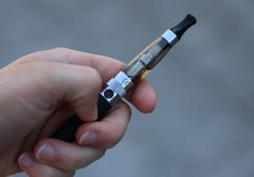 A hand holding an e-cigarette