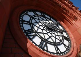 The article’s main image is of the Senedd’s red brick Pierhead clock with blue sky behind on a sunny day