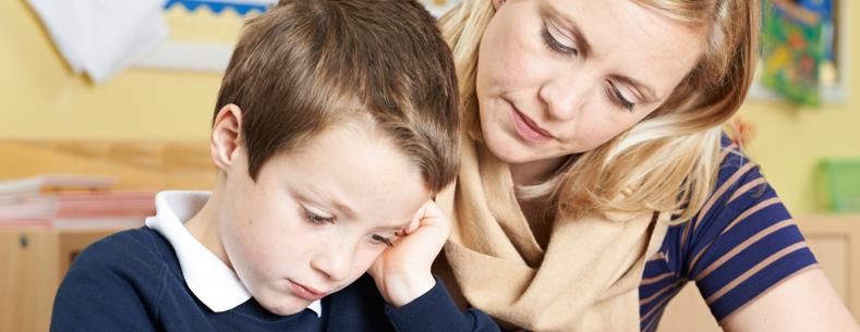 Teacher Helping School Pupil With Work