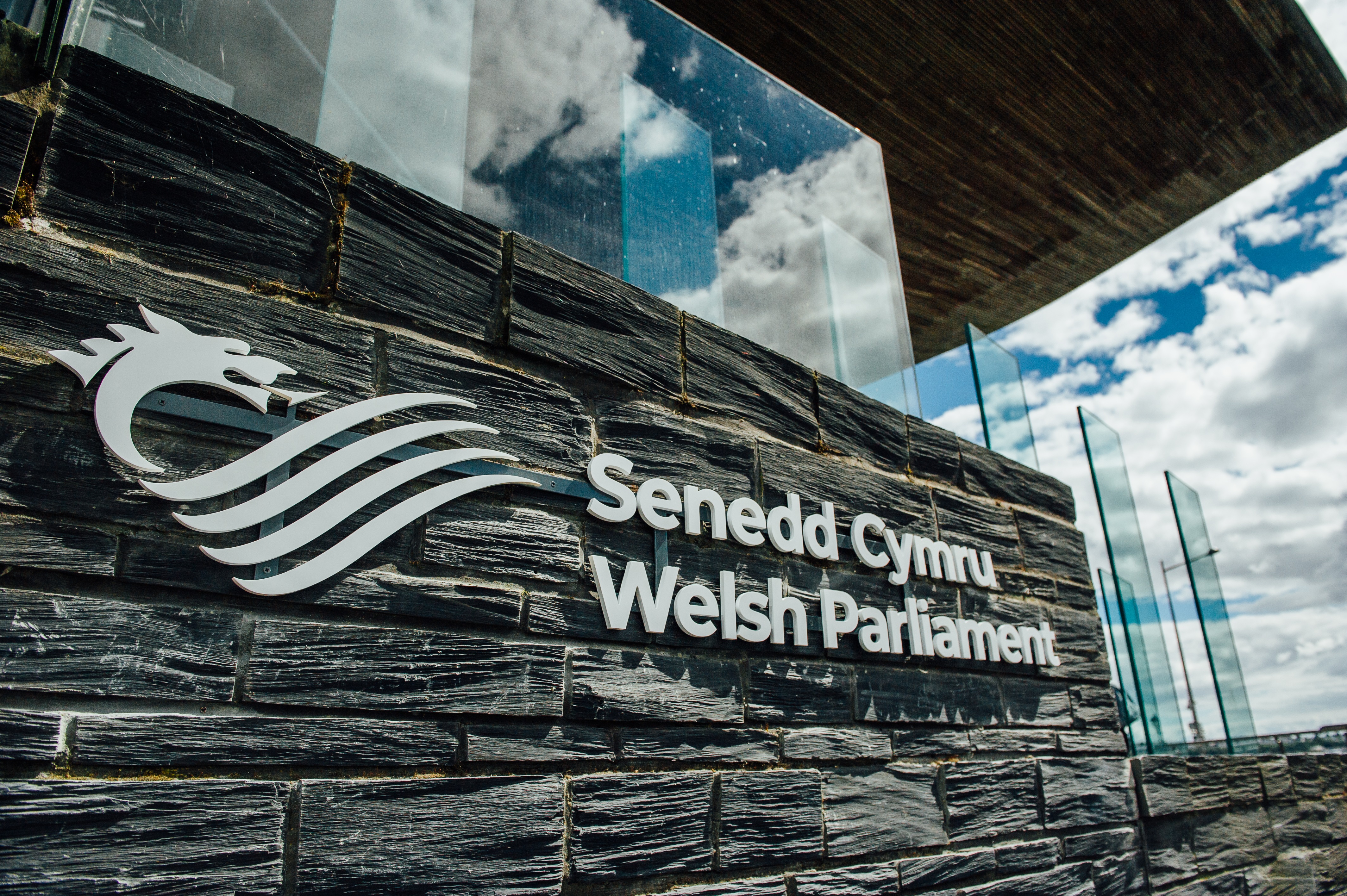 The Senedd Cymru - Welsh Parliament sign outside of the Senedd