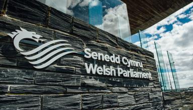 The Senedd Cymru - Welsh Parliament sign outside of the Senedd