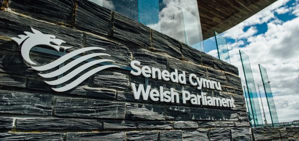 The Senedd Cymru - Welsh Parliament sign outside of the Senedd