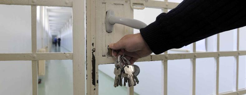 A prison gate being locked