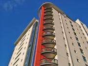 Image of a high-rise block of flats against a blue sky