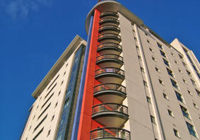 Image of a high-rise block of flats against a blue sky