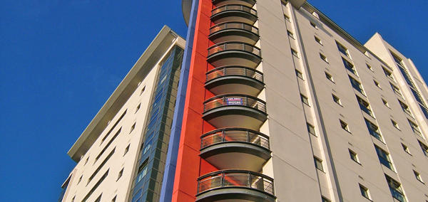 Image of a high-rise block of flats against a blue sky