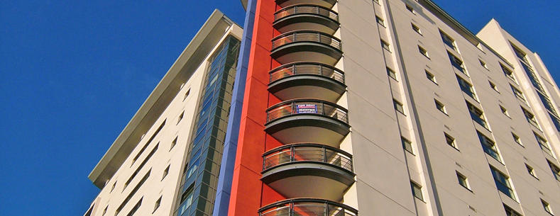 Image of a high-rise block of flats against a blue sky