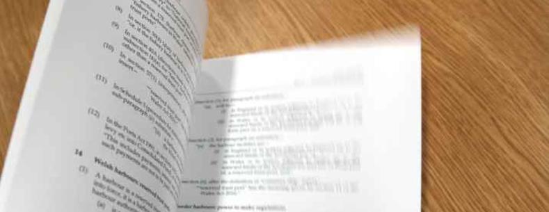 A picture of a draft bill being flicked through.