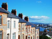 A picture of a row of terraced houses, with a city in the background.