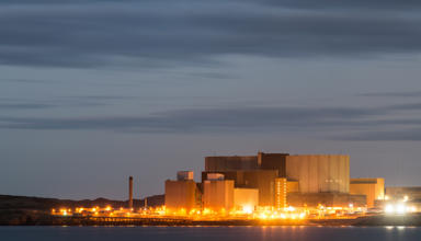 A landscape photograph of the old Wylfa power station at night.