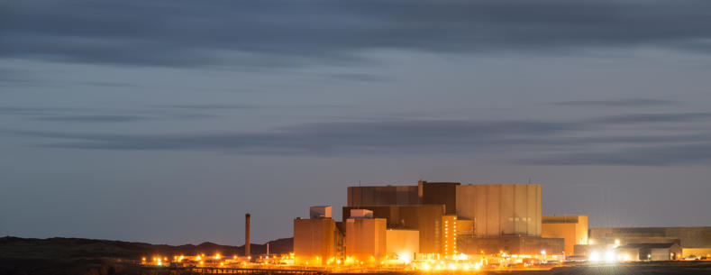 A landscape photograph of the old Wylfa power station at night.