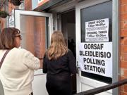 Two people entering a polling station