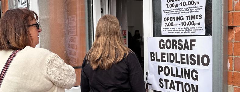 Two people entering a polling station